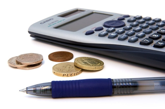 A calculator, pen and coins