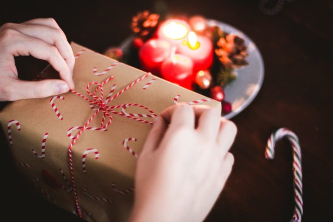 Person wrapping a Christmas gift